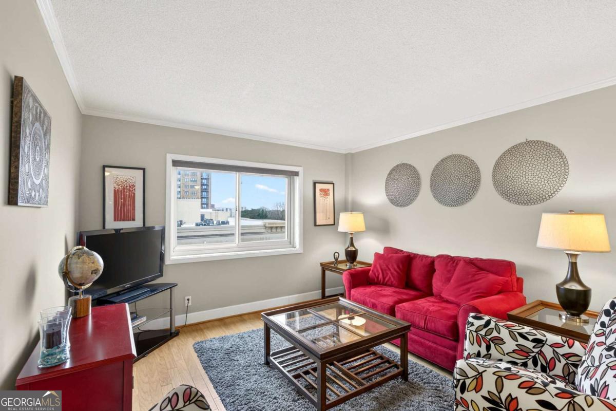 2285 Peachtree Road, Unit 1106 Atlanta, GA 30309 - Photo 7 of 27 a living room with furniture and a window