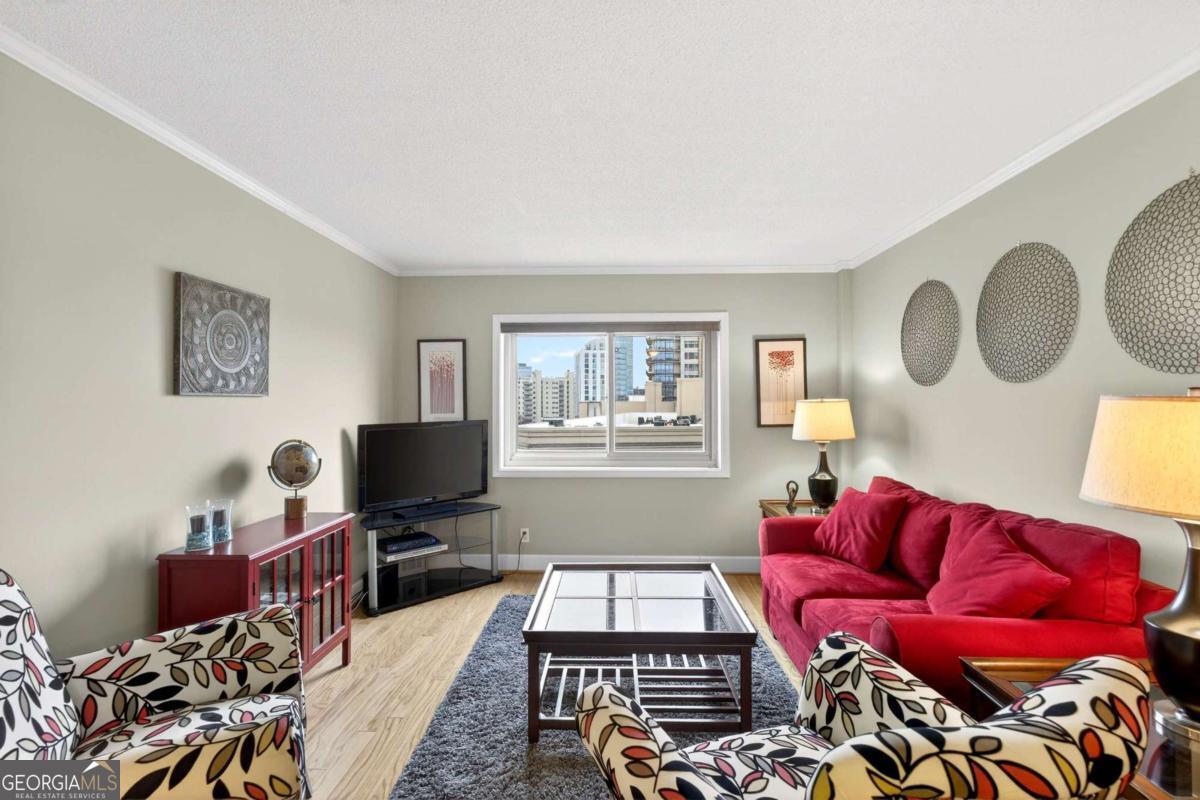 2285 Peachtree Road, Unit 1106 Atlanta, GA 30309 - Photo 8 of 27 a living room with furniture and a flat screen tv