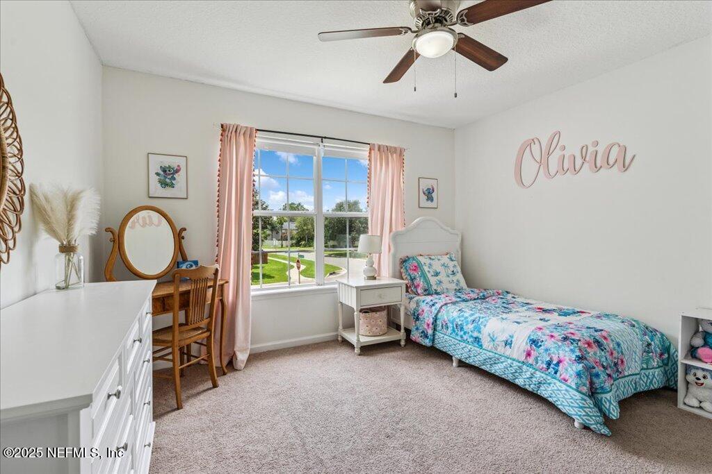 800 Marjories Way St. Augustine, FL 32092 - Photo 14 of 38 a bedroom with a bed and a chandelier