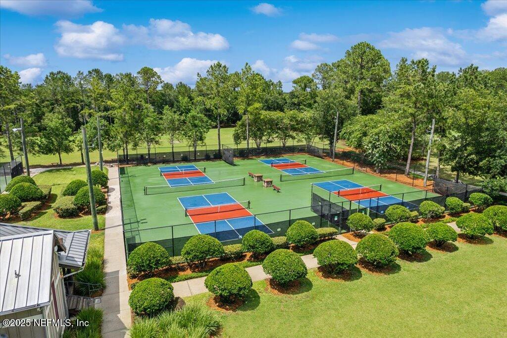 800 Marjories Way St. Augustine, FL 32092 - Photo 34 of 38 a green field with lots of plants and trees in the background