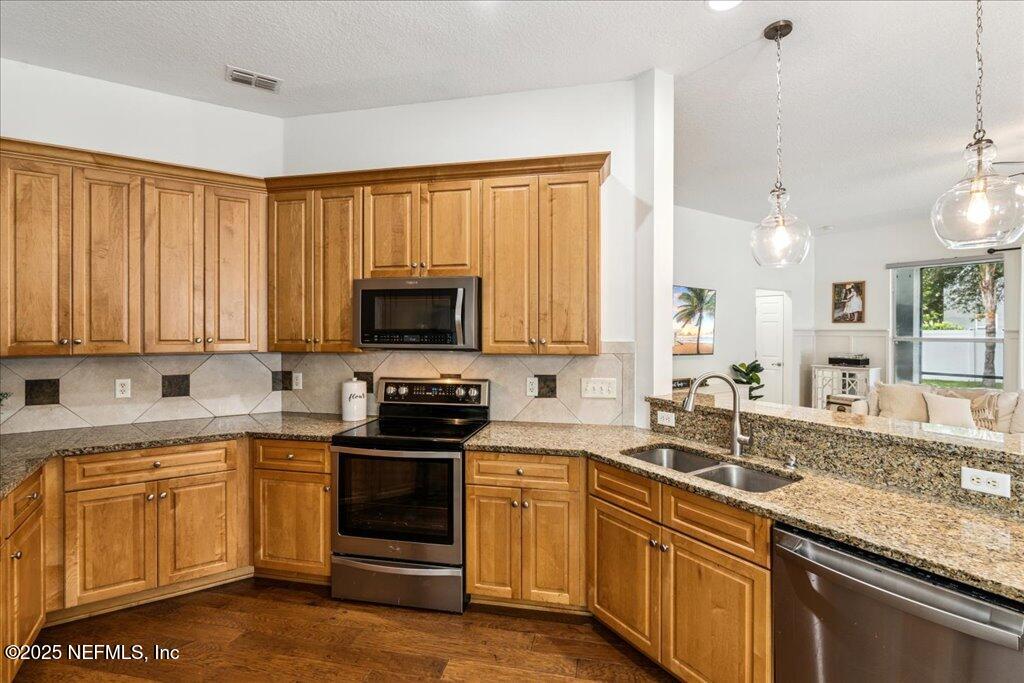 800 Marjories Way St. Augustine, FL 32092 - Photo 7 of 38 a kitchen with a sink stove and microwave