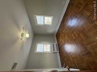 733 East Walnut Street, Unit UPPR Long Beach, NY 11561 - Photo 7 of 26 a view of empty room with wooden floor and fan