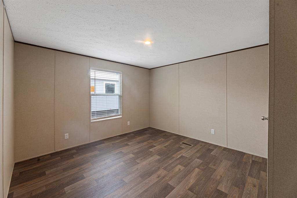 200 El Dorado Street Decatur, TX 76234 - Photo 23 of 31 a view of an empty room with wooden floor and a window