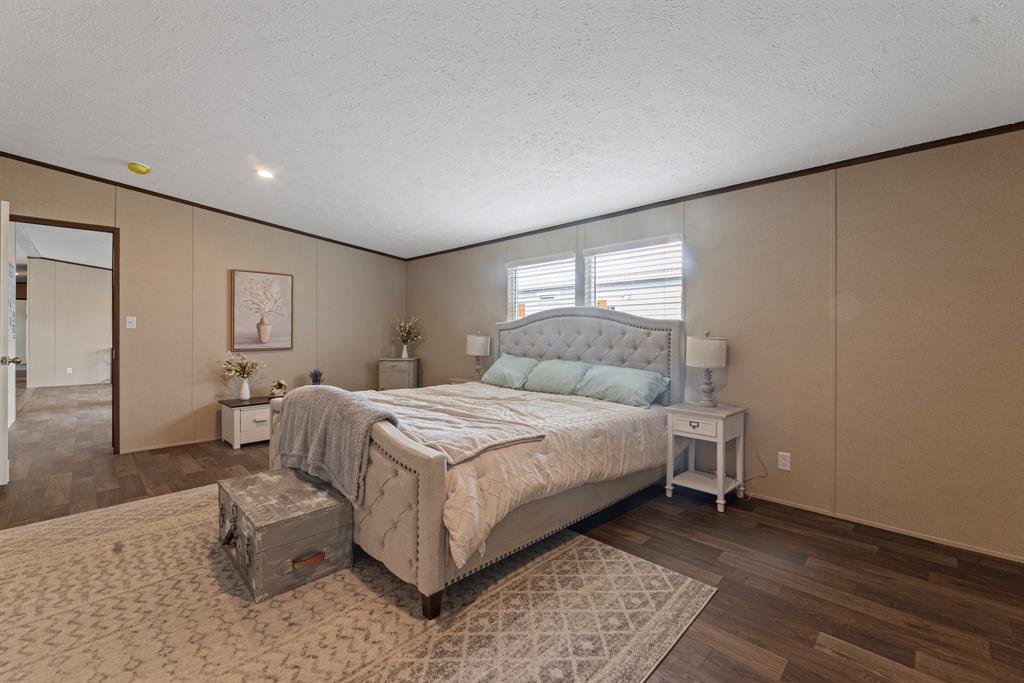 200 El Dorado Street Decatur, TX 76234 - Photo 26 of 31 a bedroom with a bed and a couch