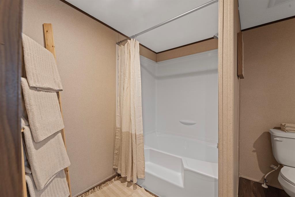 200 El Dorado Street Decatur, TX 76234 - Photo 30 of 31 a bathroom with a glass shower door and a sink