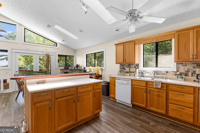 a kitchen with a stove a counter space a sink and a window