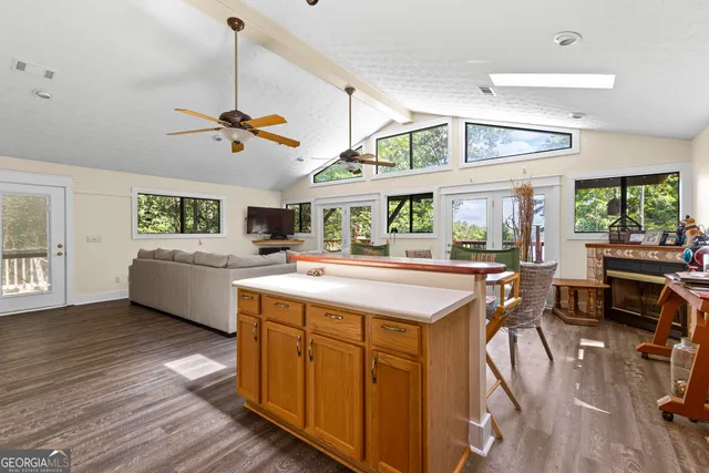 a living room with furniture a wooden floor and next to a window