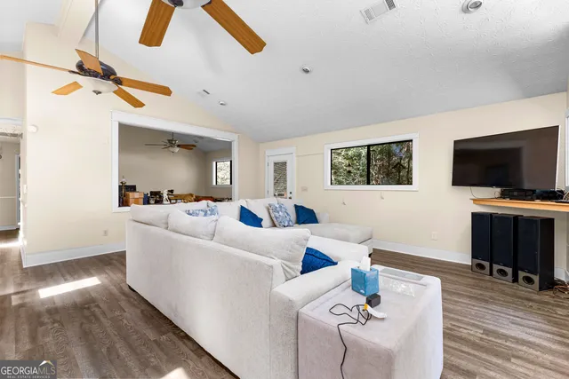 a view of a livingroom with furniture and a ceiling fan