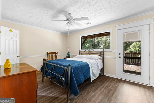 a bedroom with a bed and glass door