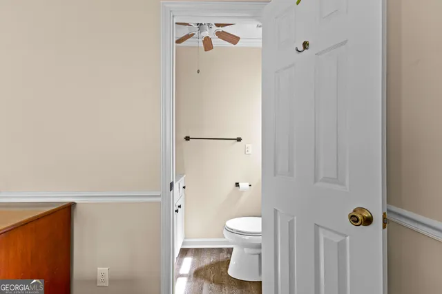 a bedroom with a bed a flat screen tv and a chandelier