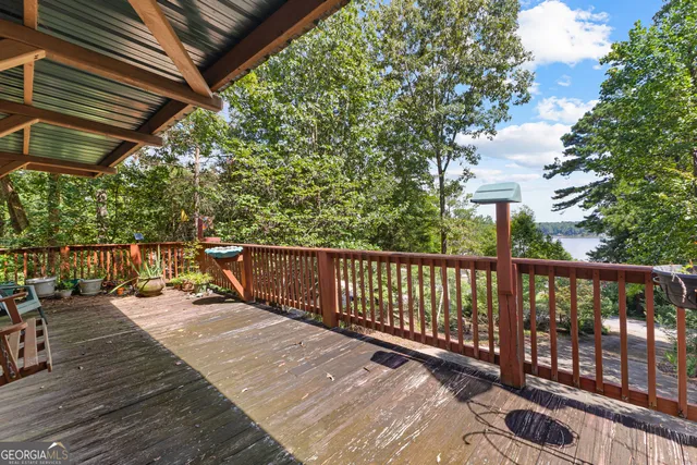 a view of a house with a yard and large trees