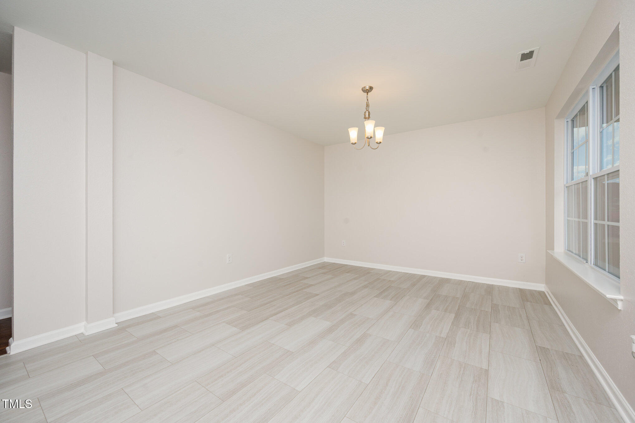 356 Botanical Court Bunnlevel, NC 28323 - Photo 12 of 31 an empty room with wooden floor and window
