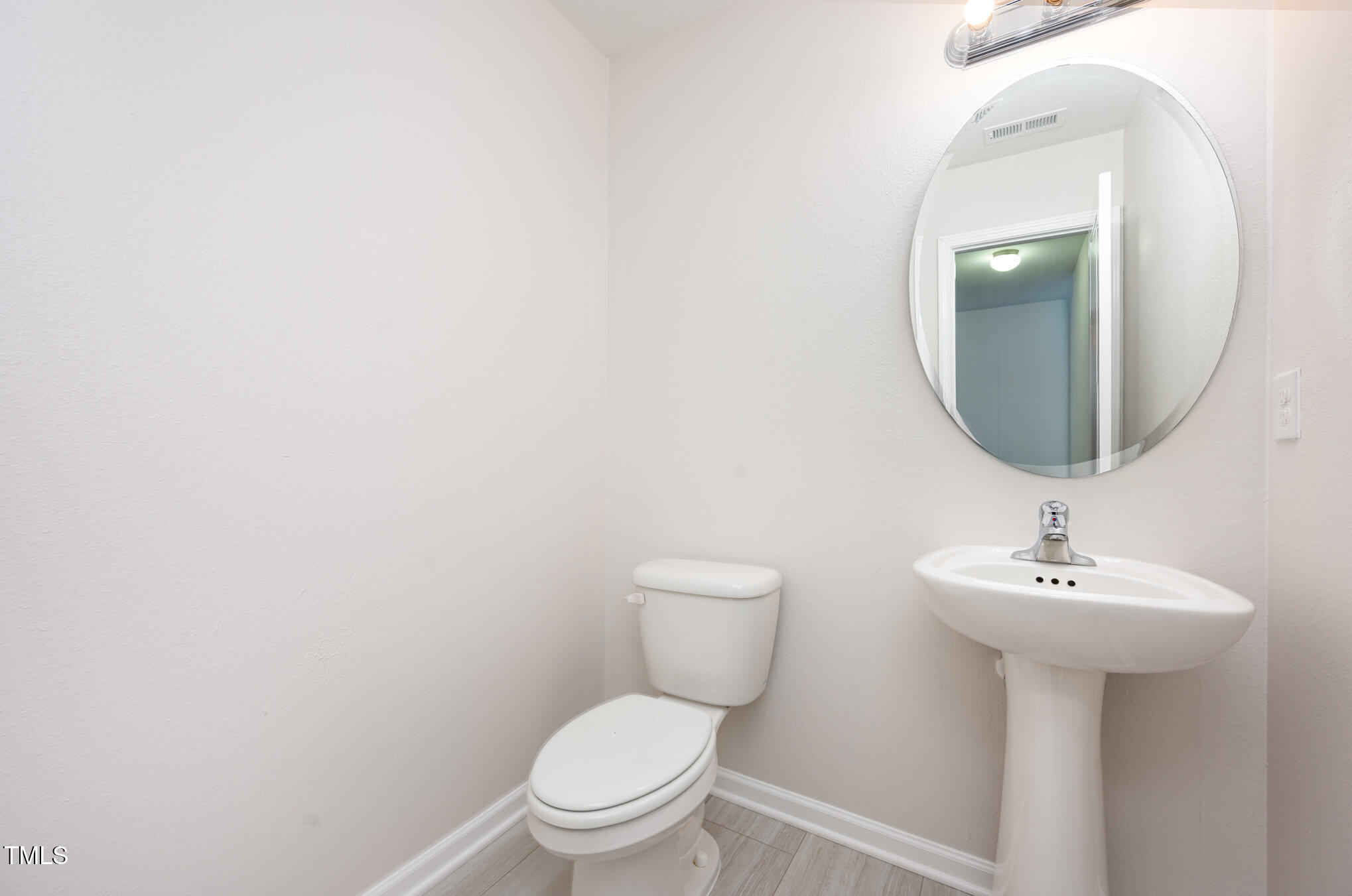 356 Botanical Court Bunnlevel, NC 28323 - Photo 13 of 31 a bathroom with a toilet sink and mirror