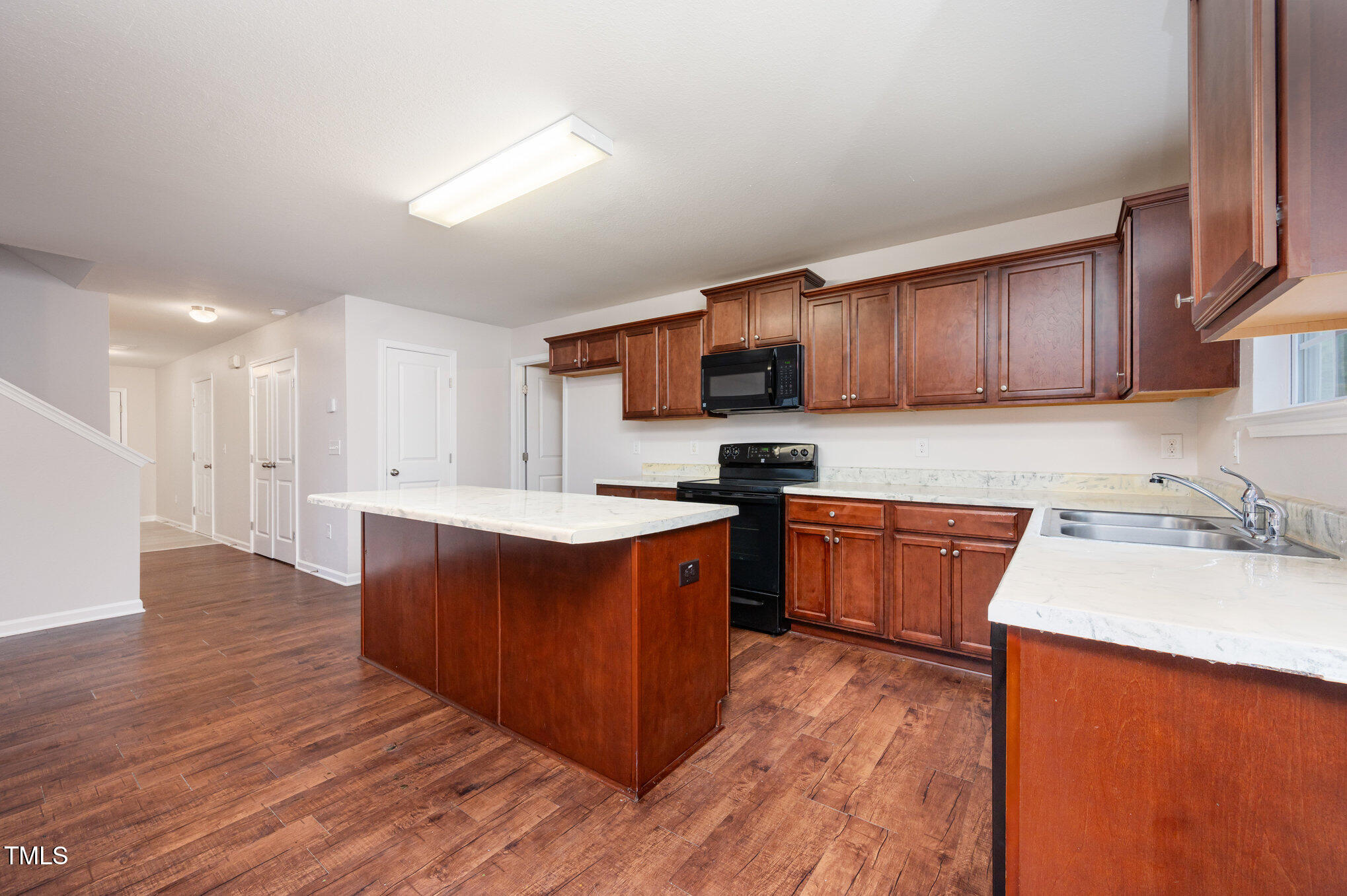 356 Botanical Court Bunnlevel, NC 28323 - Photo 9 of 31 a large kitchen with wooden floors and wooden cabinets