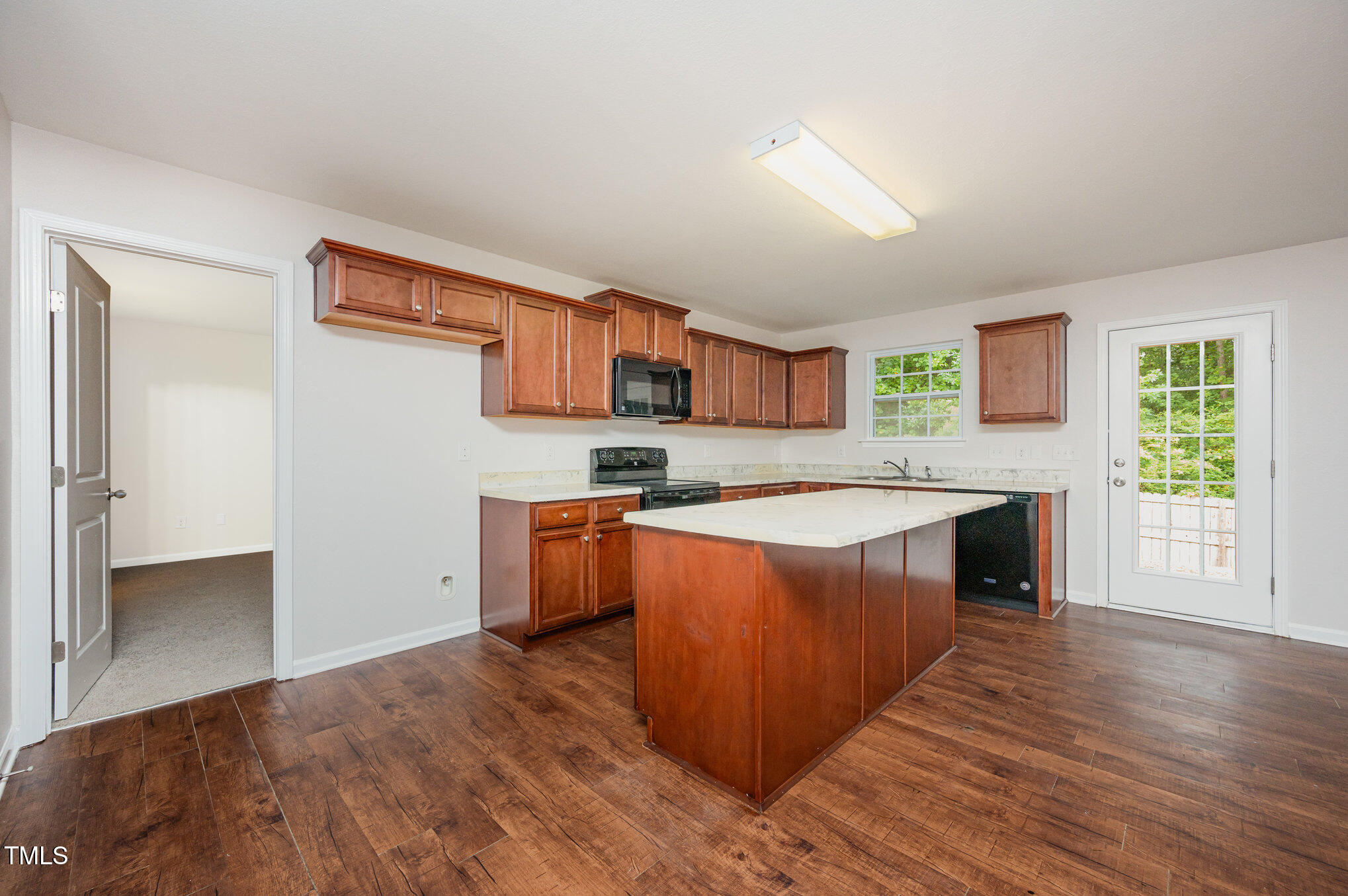 356 Botanical Court Bunnlevel, NC 28323 - Photo 10 of 31 a large kitchen with wooden floors and a fireplace