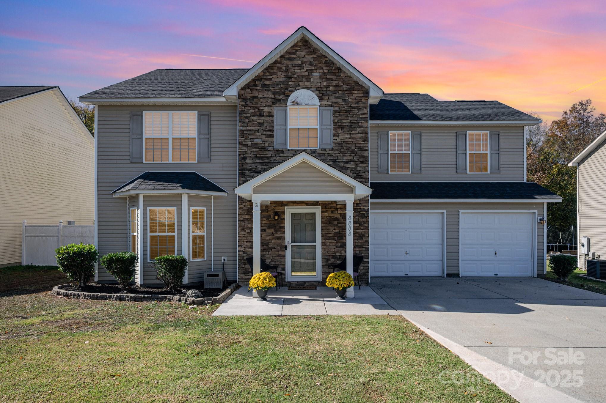 a front view of a house with a yard and garage