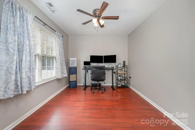 a workspace with furniture hardwood and a window