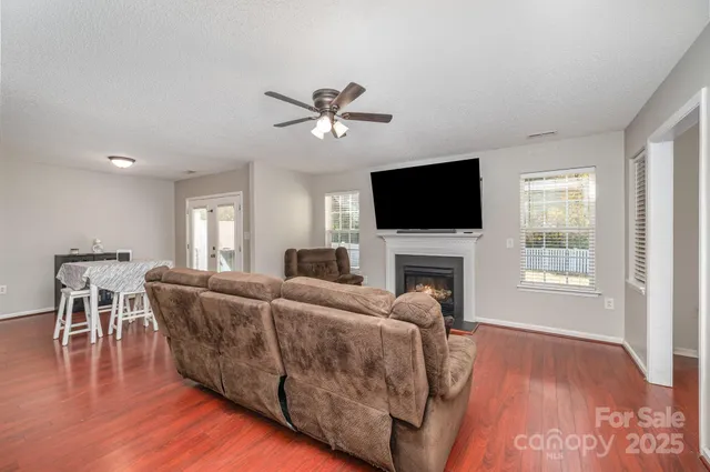 a living room with furniture a fireplace and a flat screen tv