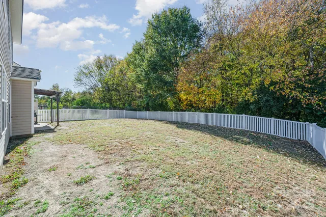 a view of a house with backyard and porch
