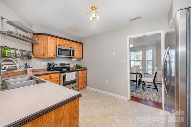a kitchen that has a table and chairs in it