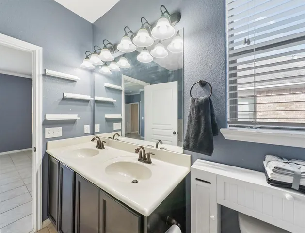 a bathroom with a sink vanity and a mirror