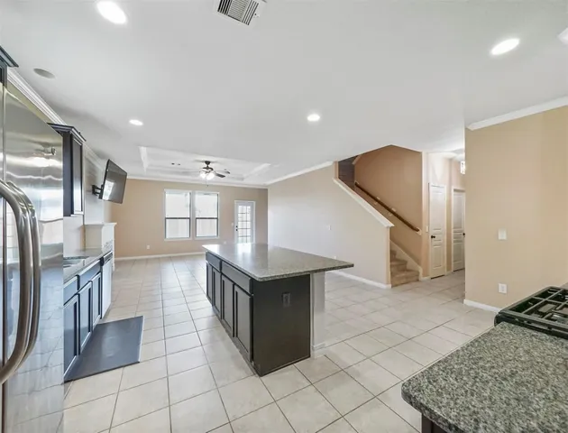 a kitchen with stainless steel appliances granite countertop a refrigerator and a stove