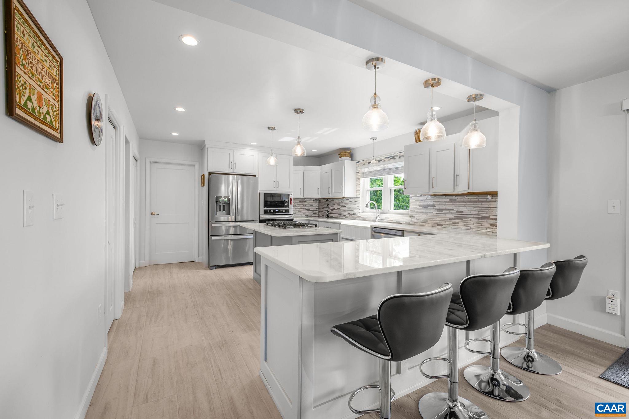1701 Harrington Road Gordonsville, VA 22942 - Photo 12 of 28 a kitchen with kitchen island stainless steel appliances a sink and cabinets