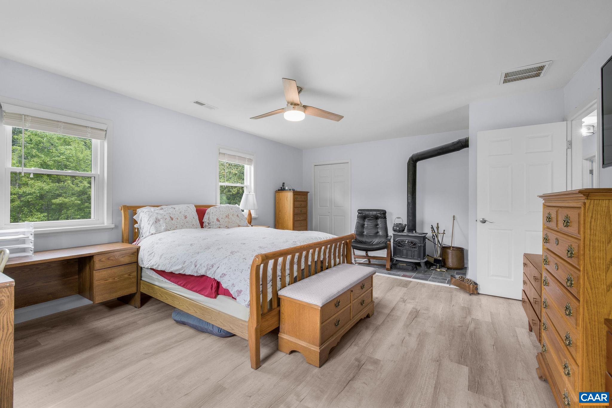 1701 Harrington Road Gordonsville, VA 22942 - Photo 18 of 28 a spacious bedroom with a bed couch and a window