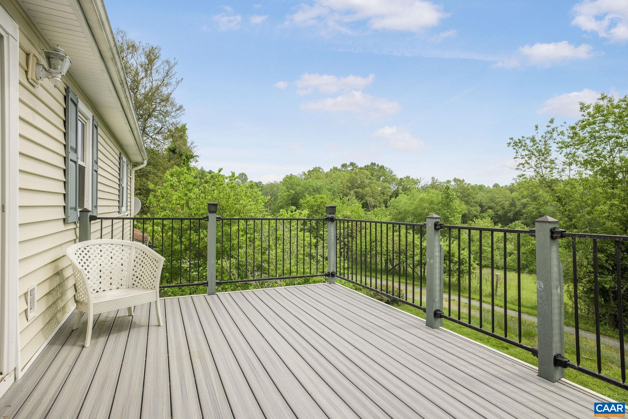 1701 Harrington Road Gordonsville, VA 22942 - Photo 23 of 28 a balcony with wooden floor next to a yard
