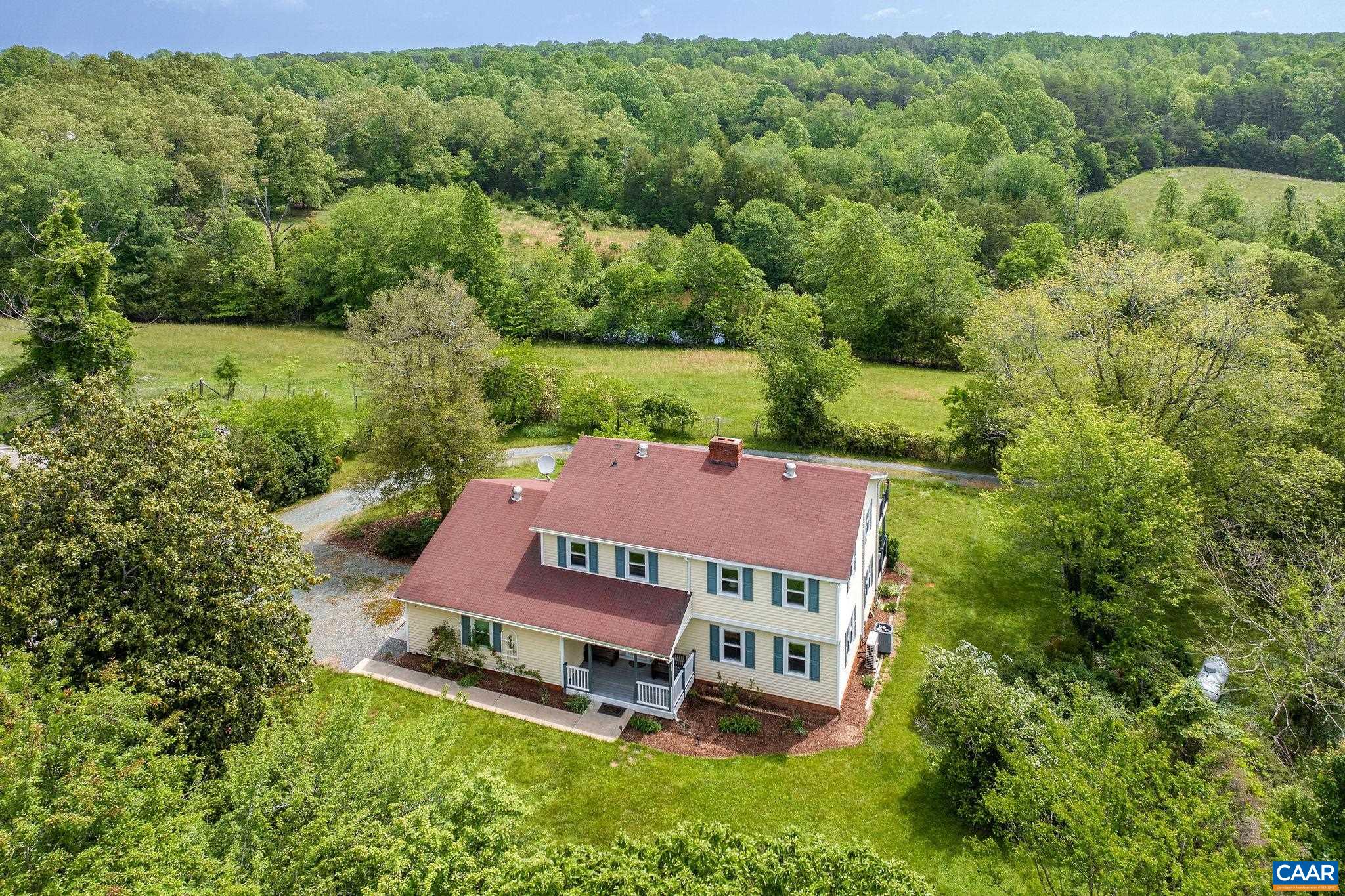 1701 Harrington Road Gordonsville, VA 22942 - Photo 4 of 28 an aerial view of a house with pool big yard and large trees