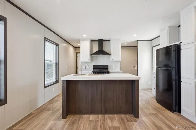 a kitchen with stainless steel appliances a refrigerator and a stove top oven