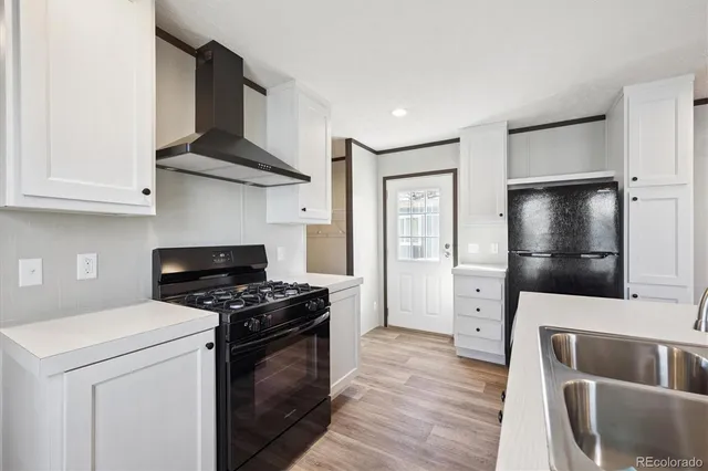 a kitchen with stainless steel appliances a stove a microwave and a refrigerator