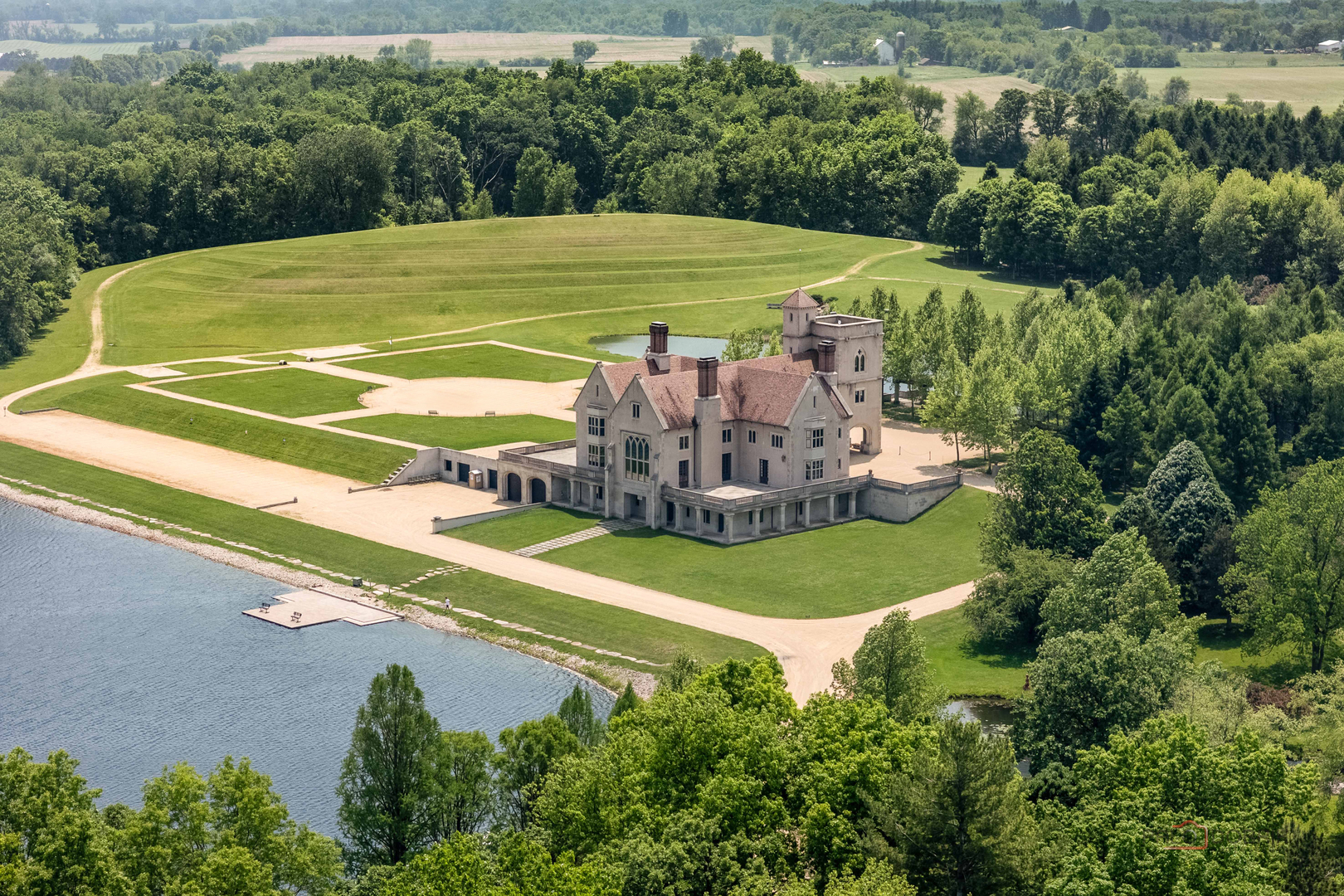 a view of a tennis ground with a large trees