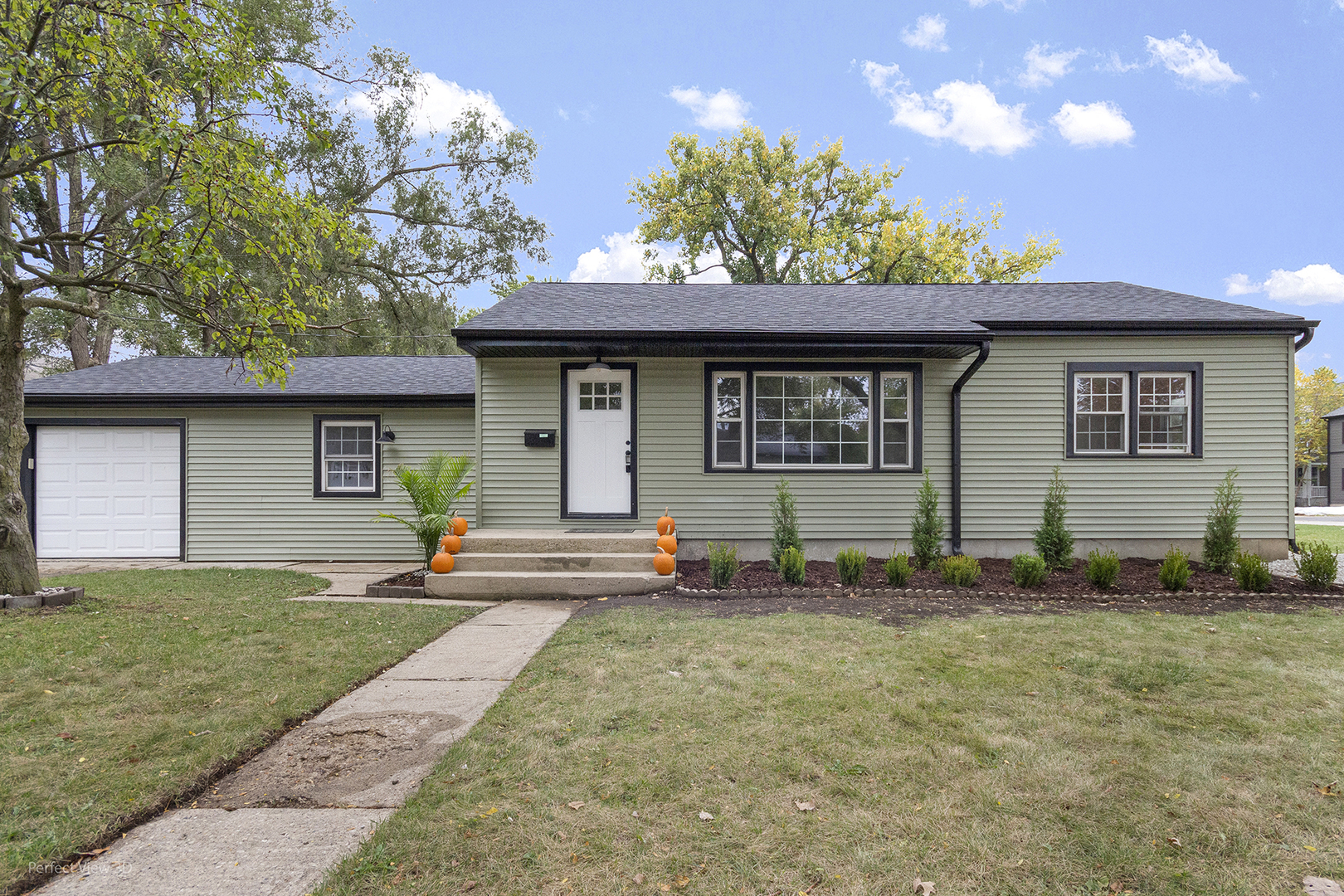 a front view of a house with a yard