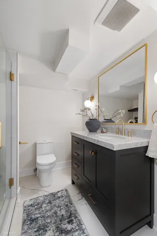 a bathroom with a sink toilet and mirror