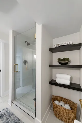 a kitchen with a refrigerator and wooden floor