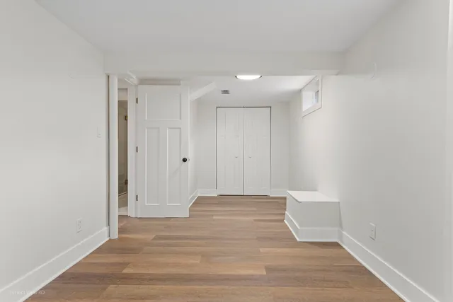 a view of a room with wooden floor