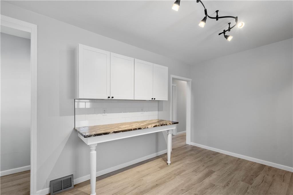 30 Evans Road Charleroi, PA 15022 - Photo 12 of 34 a kitchen with granite countertop a stove cabinets and wooden floor