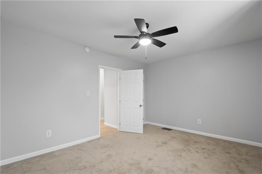 30 Evans Road Charleroi, PA 15022 - Photo 21 of 34 an empty room with a ceiling fan and windows
