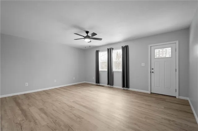 a view of an empty room with windows