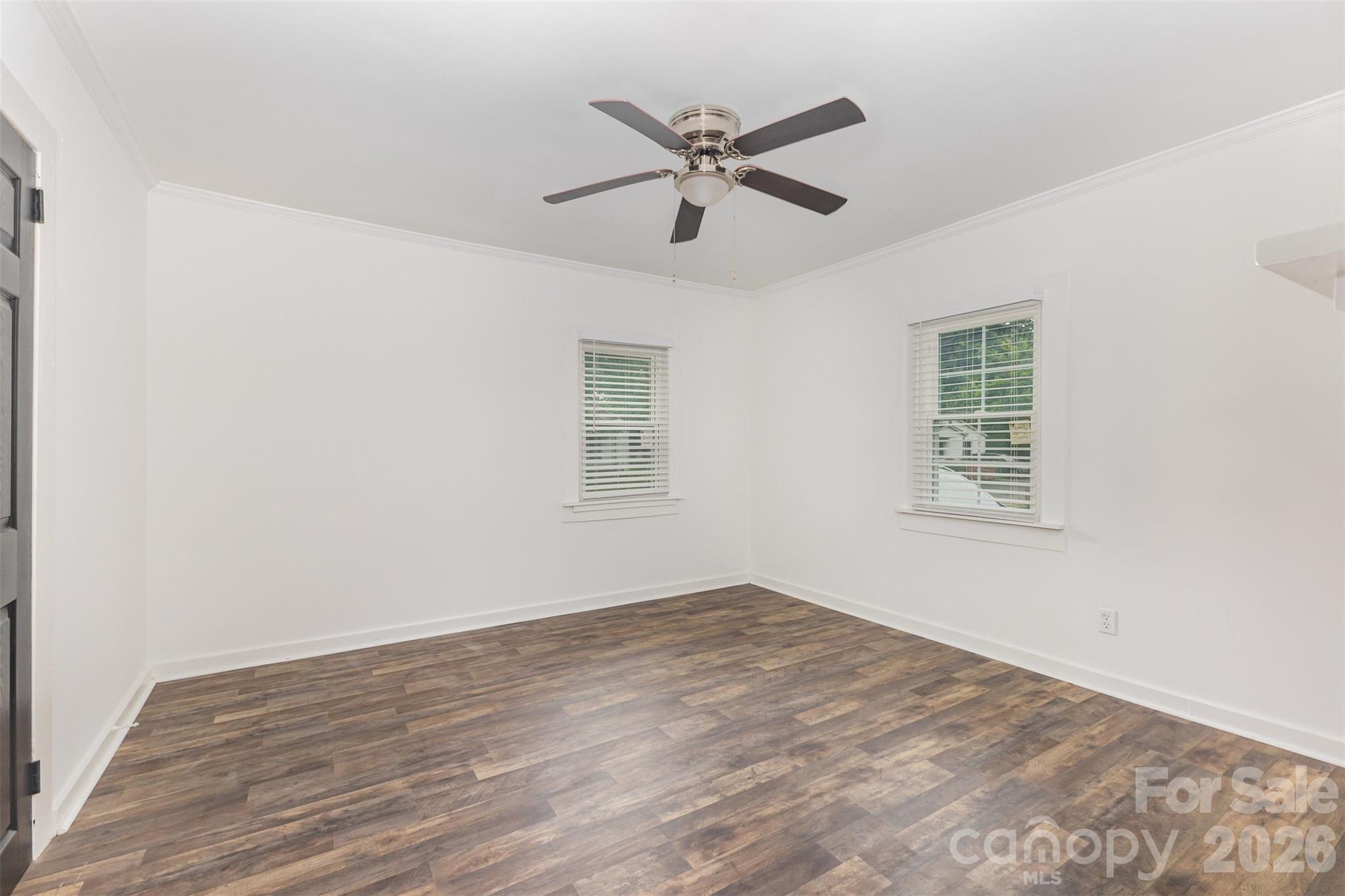 664 Simpson Street Rock Hill, SC 29730 - Photo 11 of 23 an empty room with wooden floor fan and windows