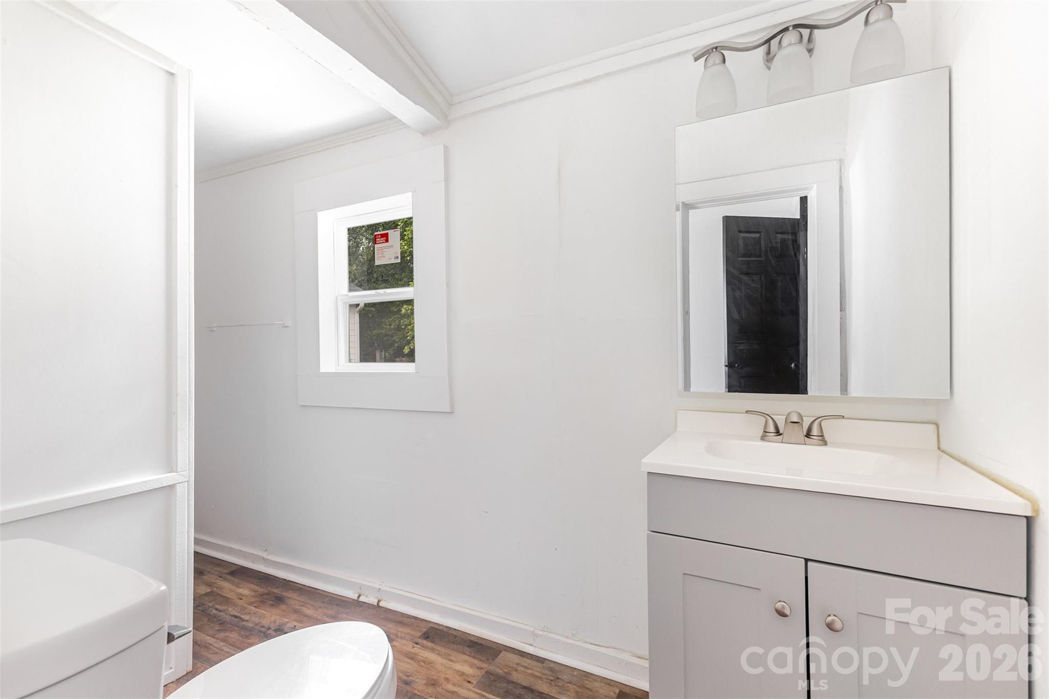 664 Simpson Street Rock Hill, SC 29730 - Photo 13 of 23 a bathroom with a sink vanity mirror and toilet