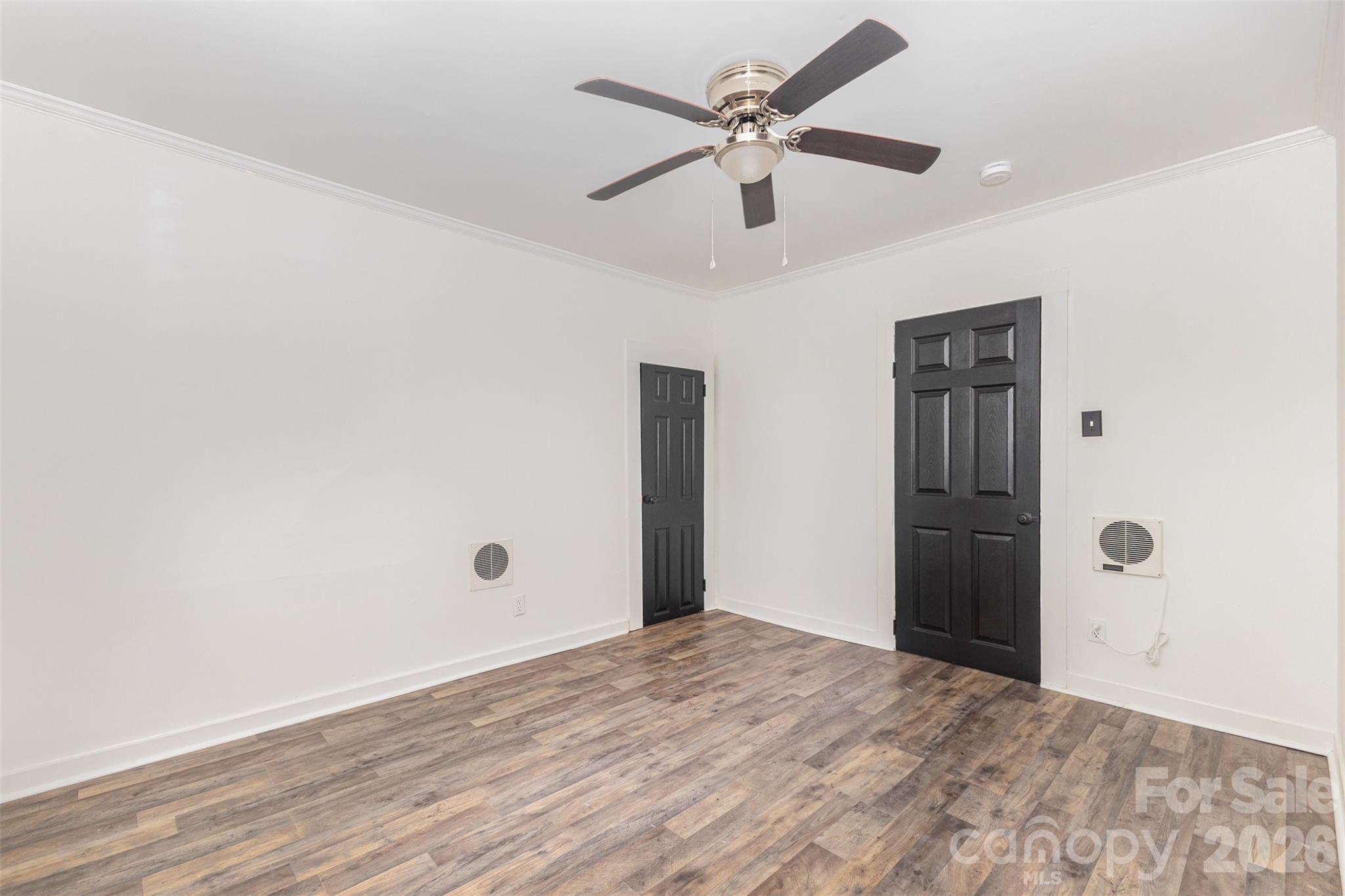 664 Simpson Street Rock Hill, SC 29730 - Photo 16 of 23 an empty room with wooden floor ceiling fan and windows