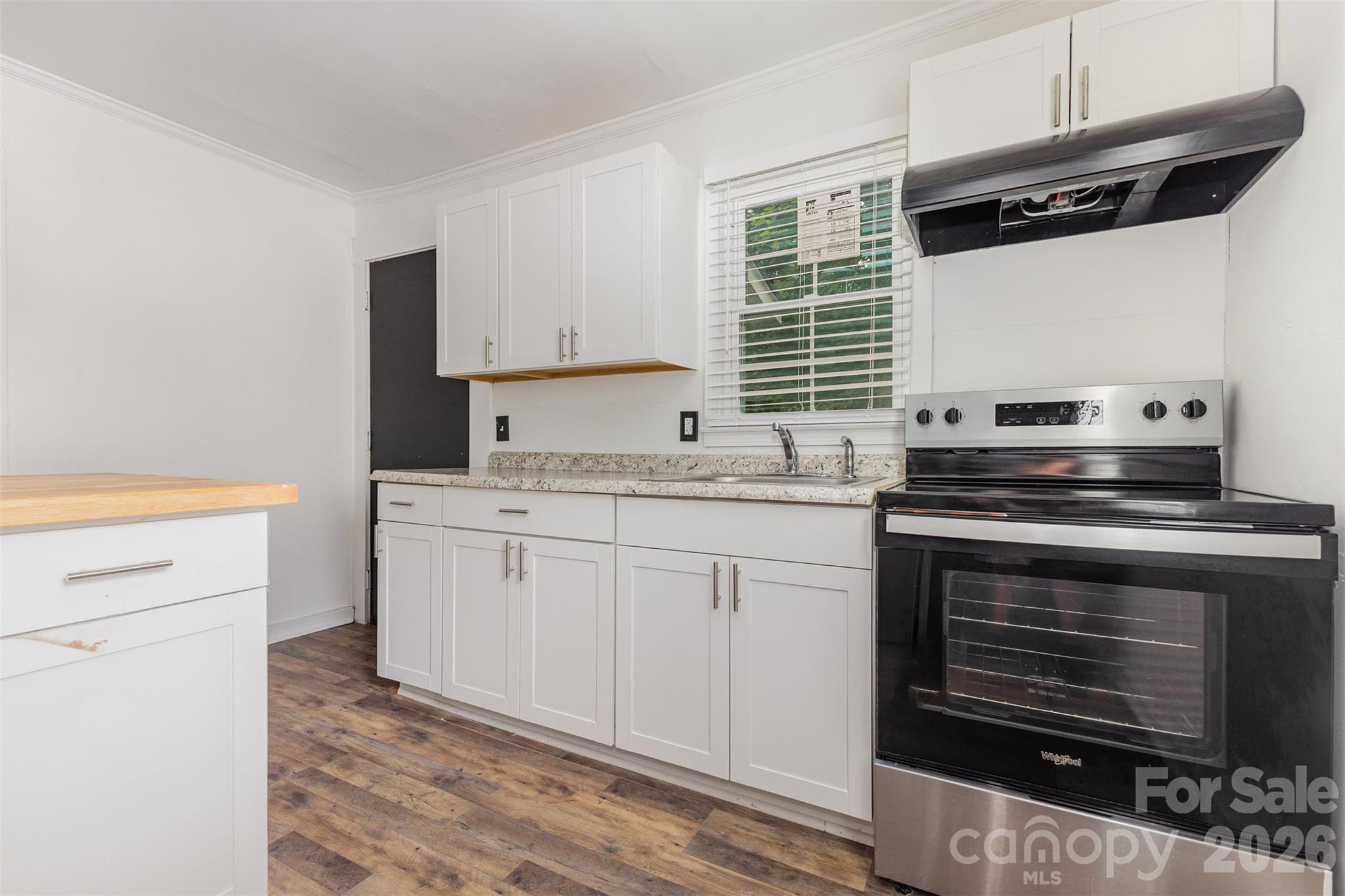 664 Simpson Street Rock Hill, SC 29730 - Photo 6 of 23 a kitchen with stainless steel appliances a stove sink and cabinets