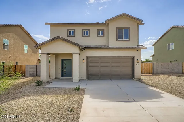 a front view of a house with a yard and garage