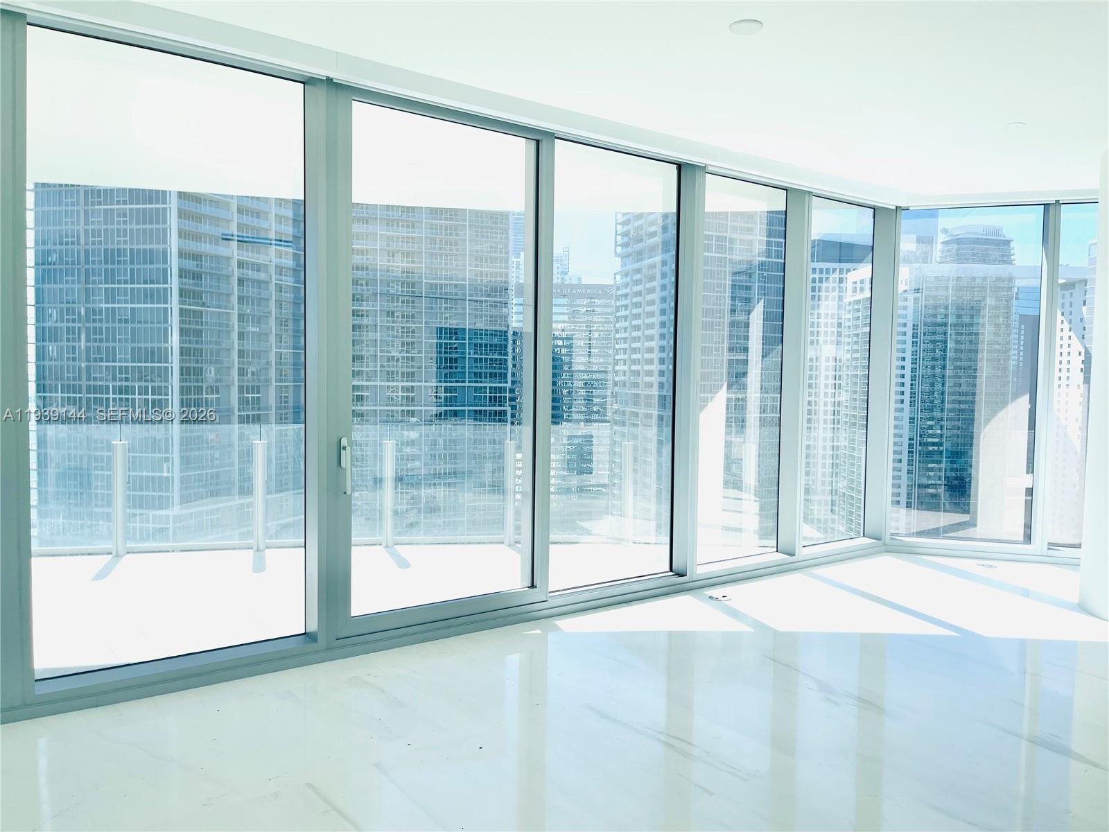 300 Biscayne Blvd Way, Unit 2807 Miami, FL 33131 - Photo 19 of 59 a view of an empty room with wooden floor and a window