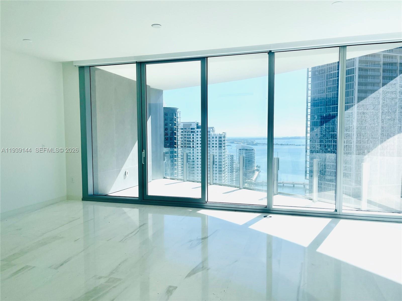300 Biscayne Blvd Way, Unit 2807 Miami, FL 33131 - Photo 21 of 59 a view of an empty room with wooden floor and a window