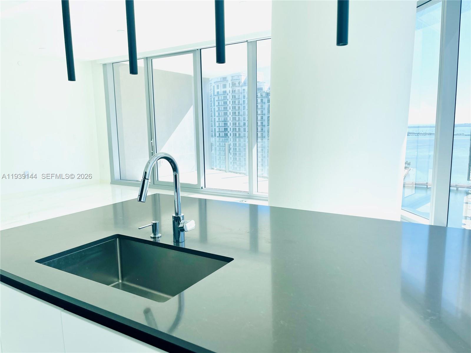 300 Biscayne Blvd Way, Unit 2807 Miami, FL 33131 - Photo 25 of 59 a kitchen with a sink and a large mirror