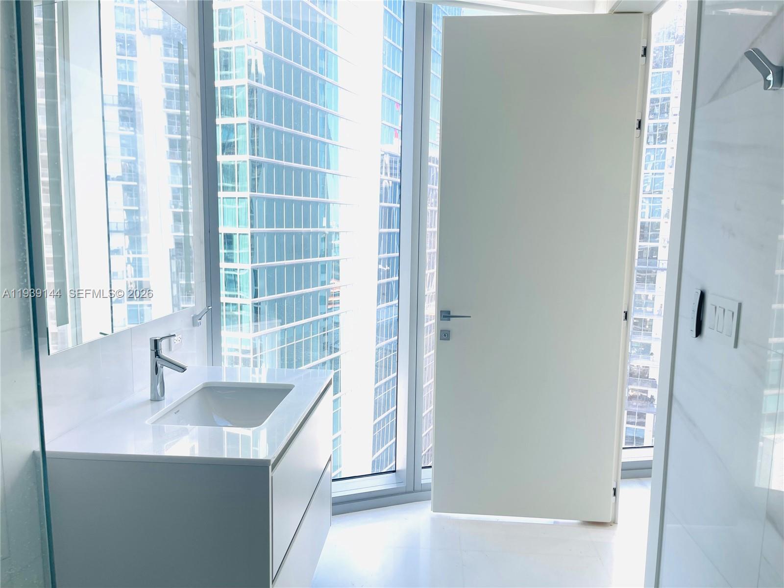 300 Biscayne Blvd Way, Unit 2807 Miami, FL 33131 - Photo 39 of 59 a bathroom with a sink and a tub