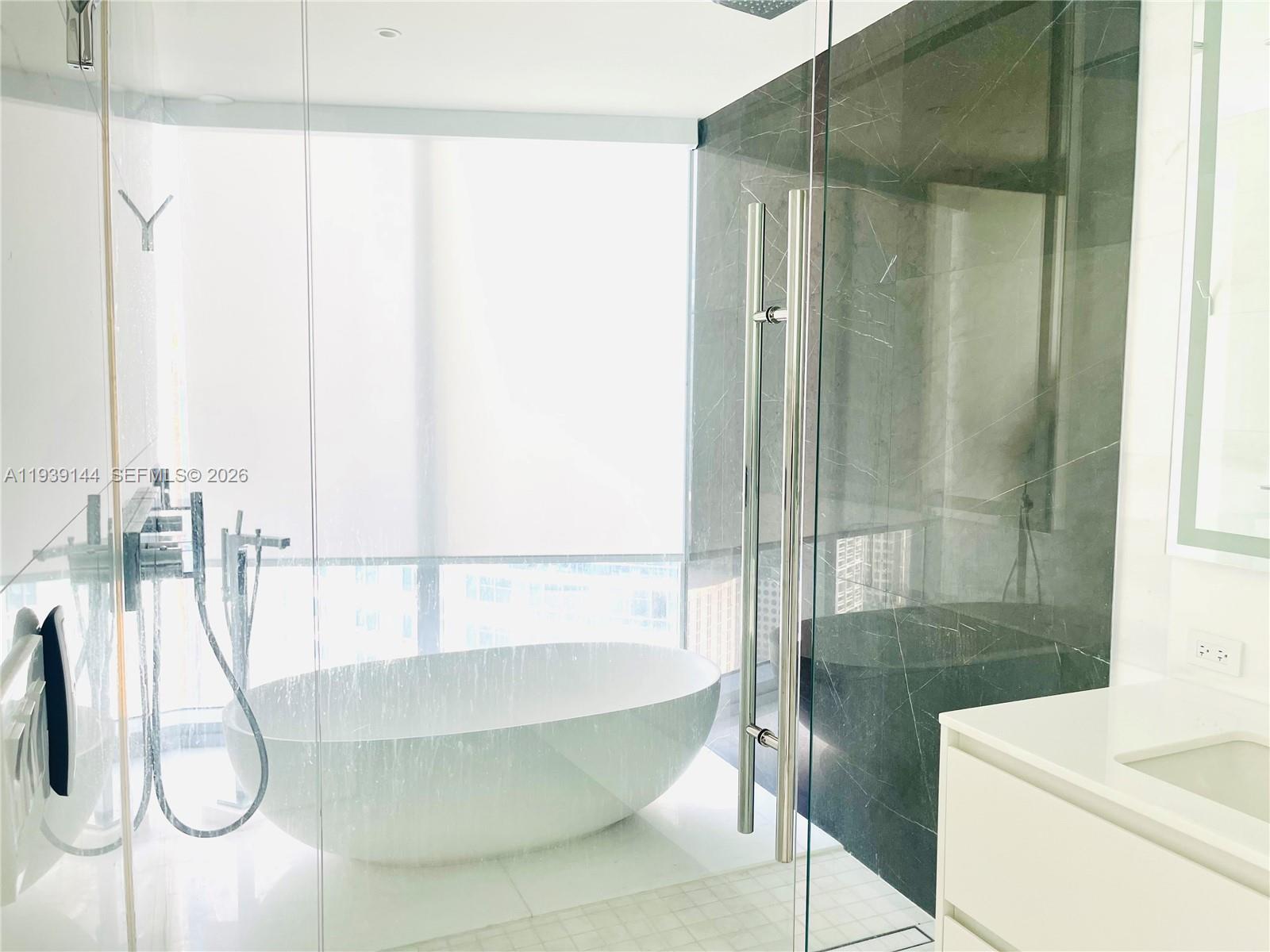 300 Biscayne Blvd Way, Unit 2807 Miami, FL 33131 - Photo 41 of 59 a bathroom with a sink and shower